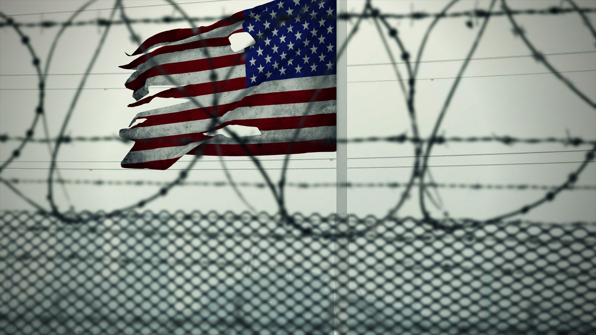 American flag behind barbwire